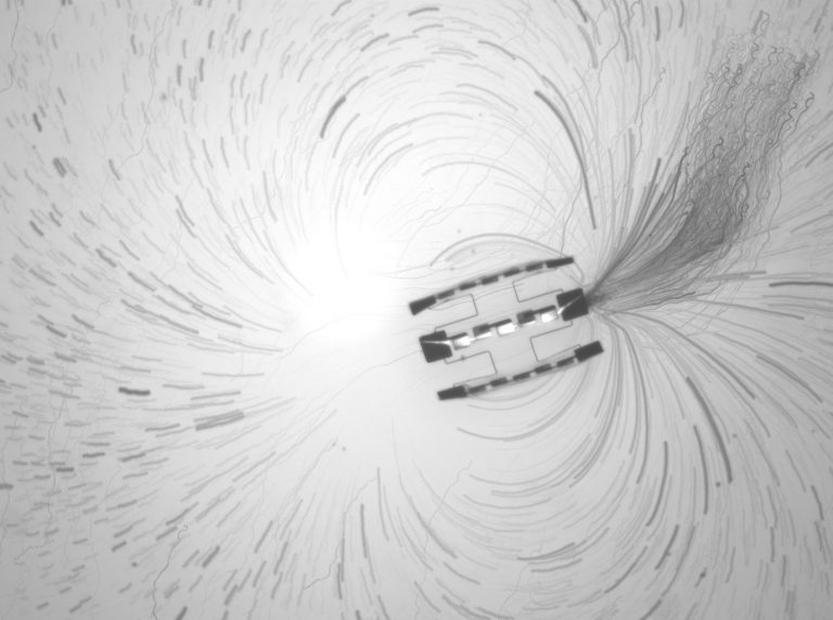 A projected timelapse of tracer particle trajectories near a robot consisting of three motors tied together.. (Credit: Lucas Hanson and William Reinhardt, University of Pennsylvania)
